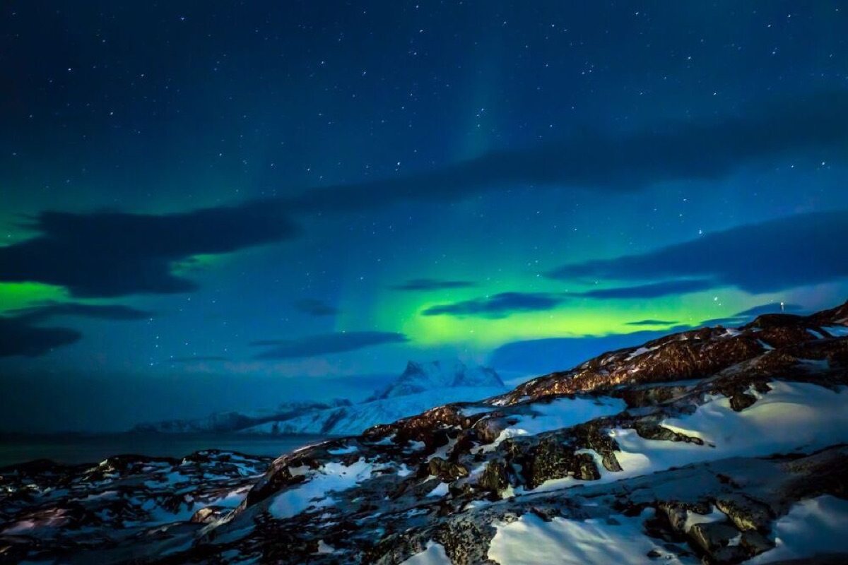 Northern lights over the fjord and mountains near Nuuk city